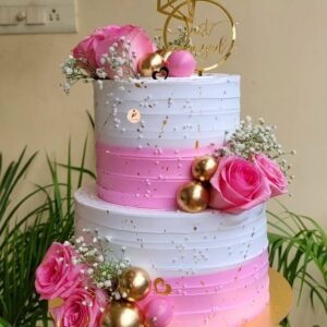 Elegant Pink Harmony Engagement Cake with ring topper and gold spheres