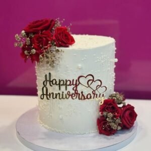 elegant anniversary cake with  red and white palette with gold highlights